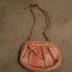 Coral colored handbag with shoulder strap